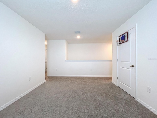 unfurnished room with carpet floors and a textured ceiling