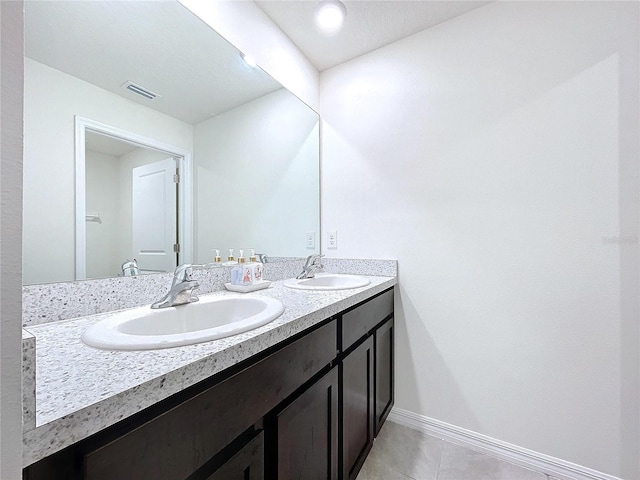 bathroom featuring tile patterned flooring and vanity