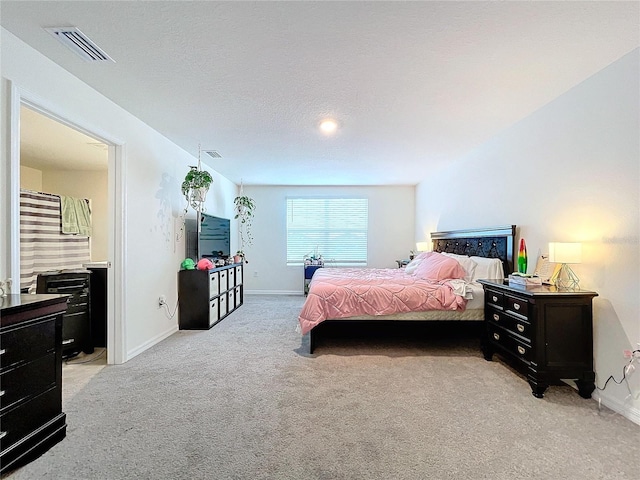 carpeted bedroom featuring a textured ceiling