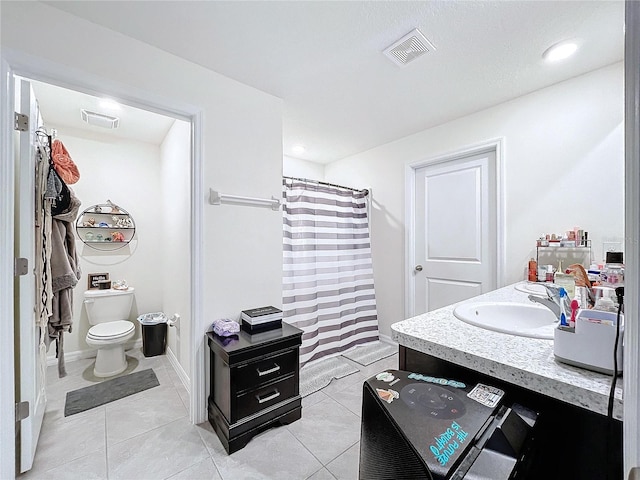 bathroom featuring a shower with curtain, tile patterned floors, vanity, and toilet