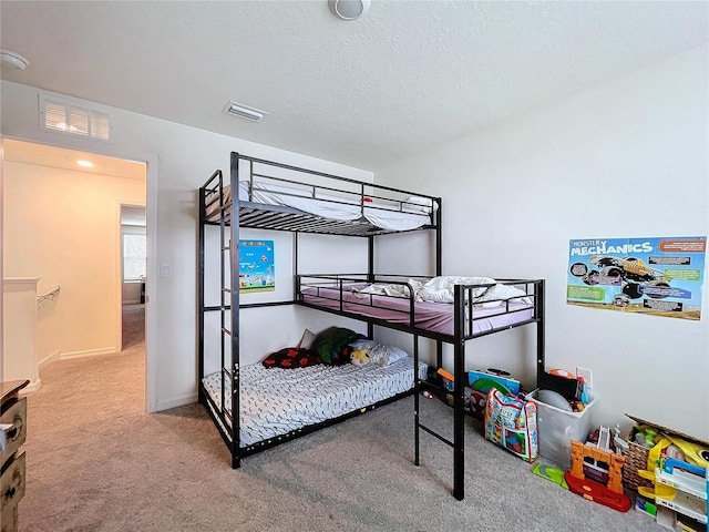 bedroom with carpet flooring and a textured ceiling