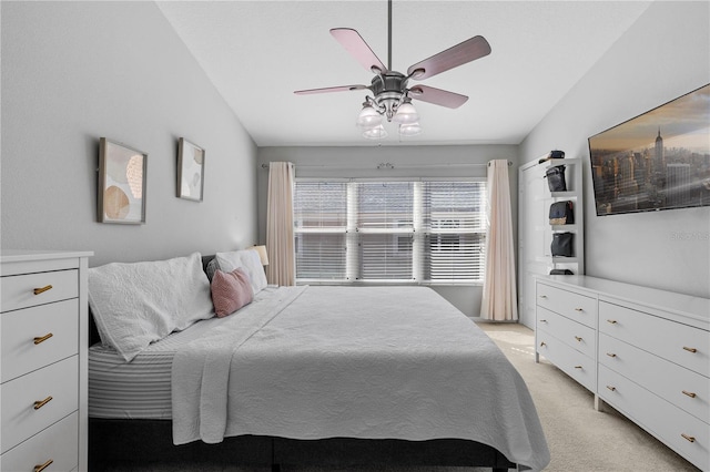 bedroom featuring vaulted ceiling, ceiling fan, and light colored carpet