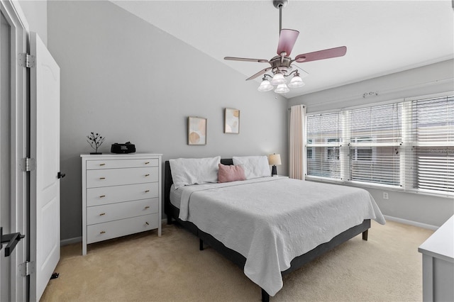 carpeted bedroom featuring lofted ceiling and ceiling fan