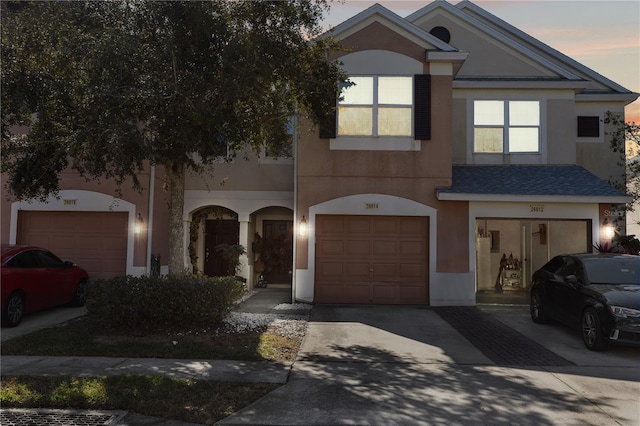 26614 Castleview Way, Wesley Chapel, FL 33544 - view of front of house featuring stucco siding, a garage, driveway, and roof with shingles