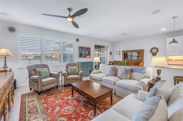 living room featuring light tile patterned floors and ceiling fan