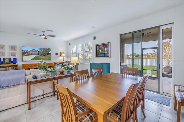 tiled dining area featuring ceiling fan