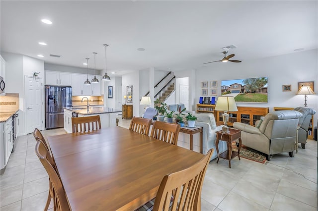 tiled dining area with sink and ceiling fan