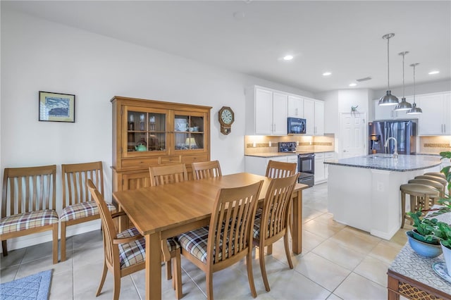 dining area with light tile patterned flooring and sink