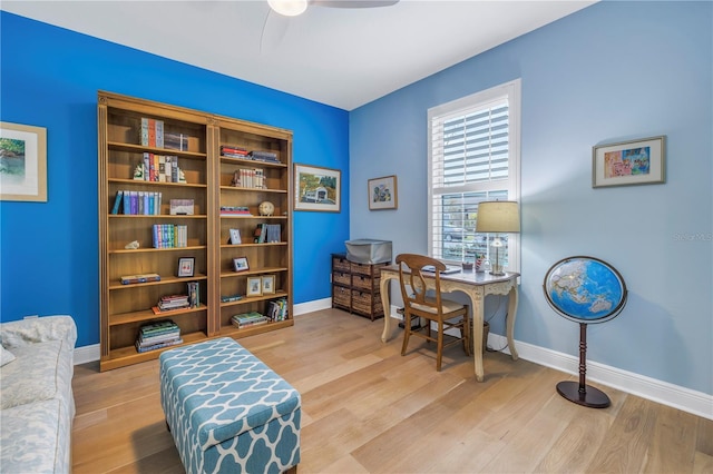 home office with ceiling fan and light hardwood / wood-style floors