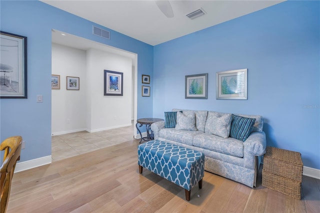 living room featuring ceiling fan and light wood-type flooring