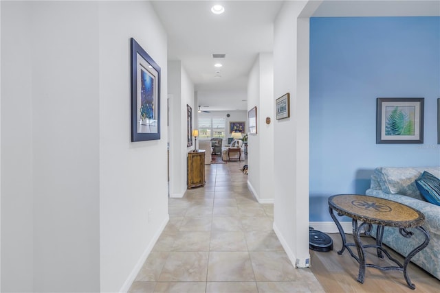 corridor featuring light tile patterned floors