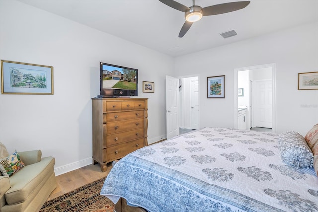 bedroom featuring hardwood / wood-style flooring, ceiling fan, and ensuite bathroom