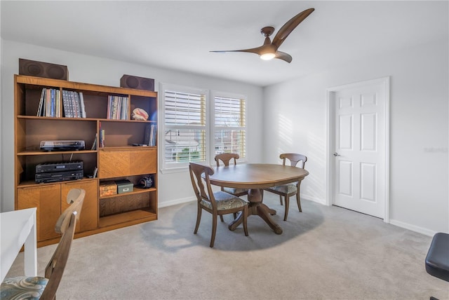 carpeted dining area featuring ceiling fan