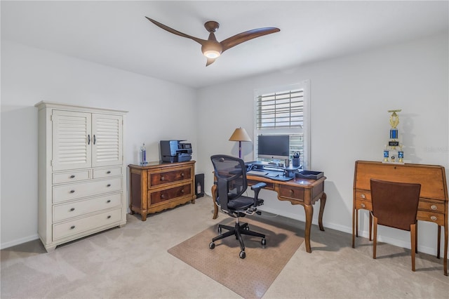 carpeted office space with ceiling fan