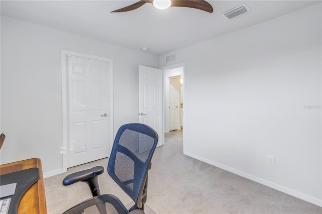 home office with ceiling fan and light carpet