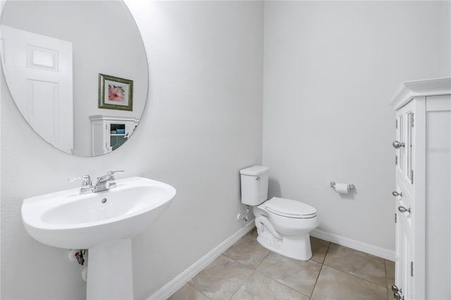 bathroom featuring tile patterned flooring, sink, and toilet