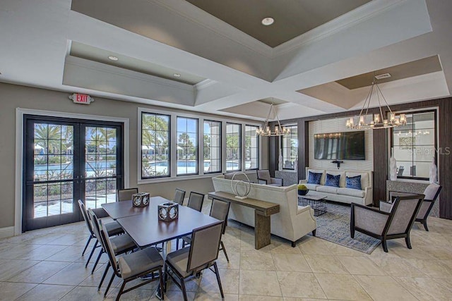 tiled dining space featuring french doors, a tray ceiling, a chandelier, and crown molding