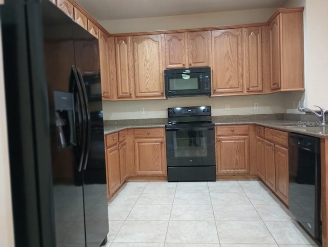 kitchen featuring sink, black appliances, and light tile patterned flooring