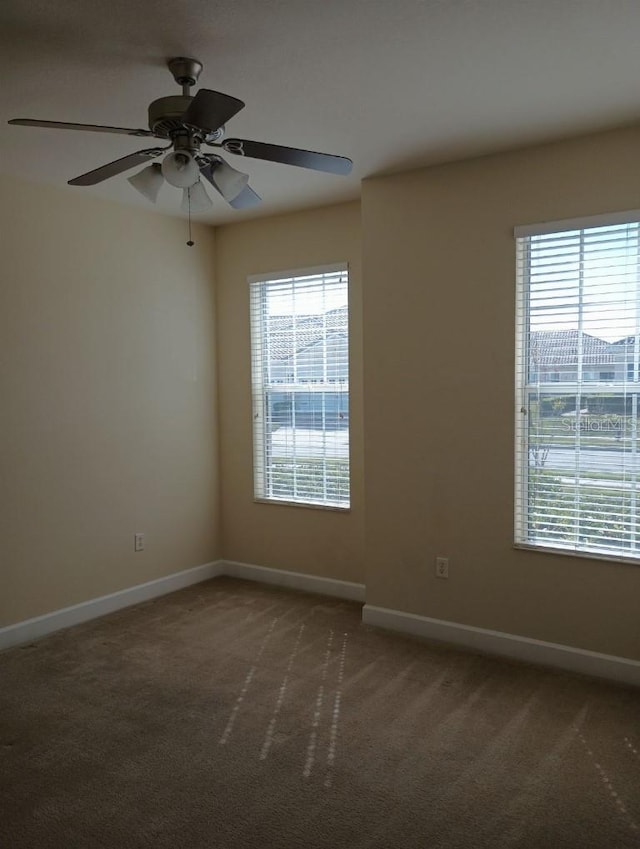 unfurnished room with ceiling fan and carpet flooring