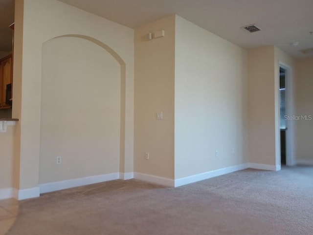 spare room with light colored carpet