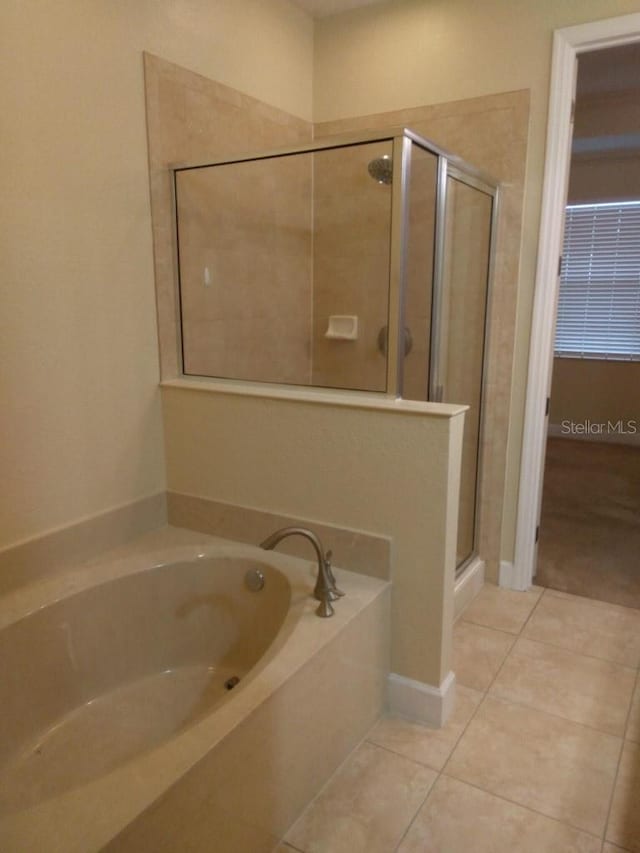 bathroom with tile patterned flooring and plus walk in shower