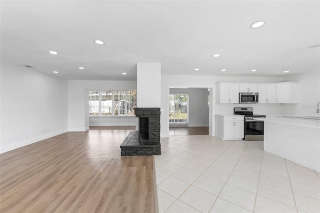 unfurnished living room with a stone fireplace