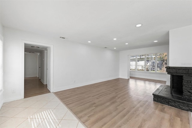 living room with a fireplace and light hardwood / wood-style flooring