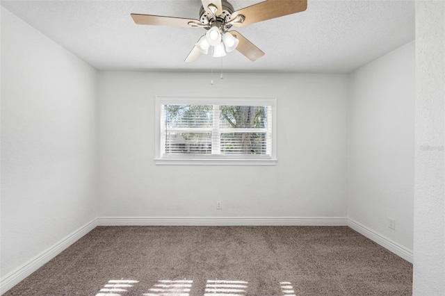 spare room featuring ceiling fan and carpet