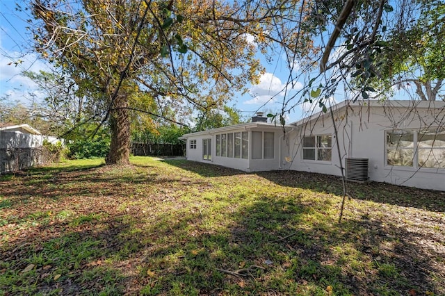 view of yard featuring central AC and a sunroom