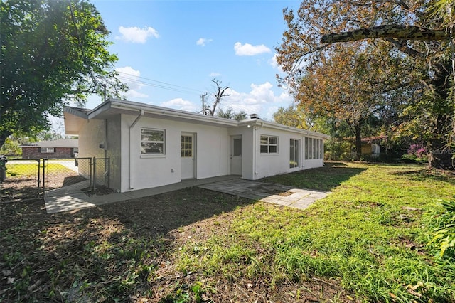 back of property featuring a lawn