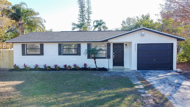 single story home featuring a garage and a front lawn