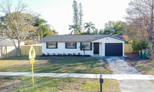 ranch-style house with a garage and a front yard