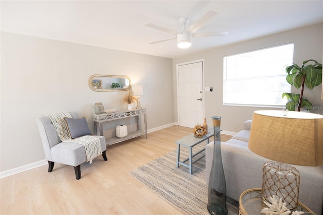 living area with ceiling fan and light hardwood / wood-style flooring