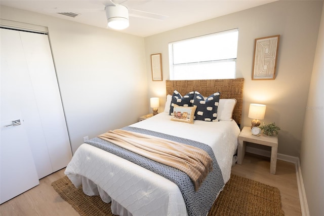 bedroom with ceiling fan, a closet, and light wood-type flooring