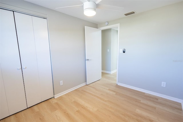 unfurnished bedroom with ceiling fan, a closet, and light hardwood / wood-style flooring