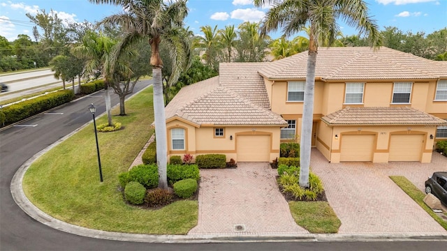 view of front of house featuring a garage and a front lawn