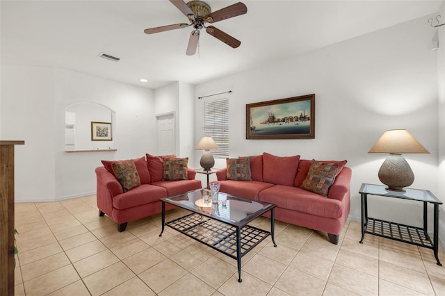 living room featuring light tile patterned floors and ceiling fan