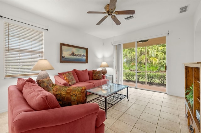 tiled living room with ceiling fan