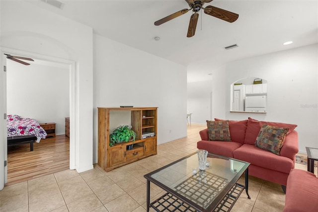 tiled living room featuring ceiling fan