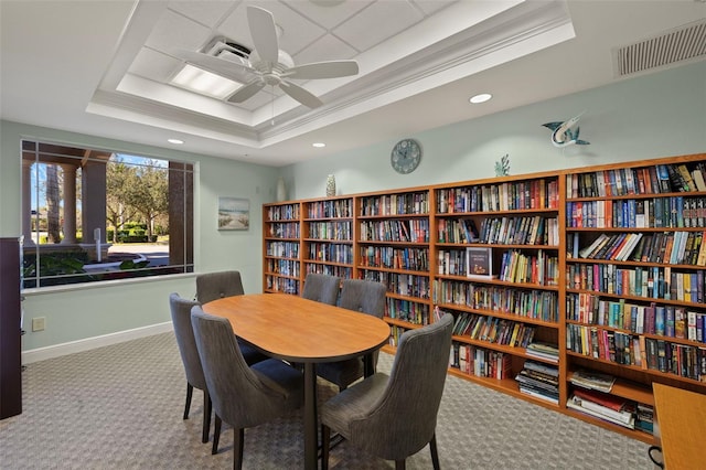 interior space featuring ornamental molding, ceiling fan, and a tray ceiling