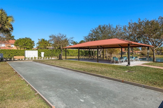 surrounding community featuring a gazebo, a water view, and a lawn