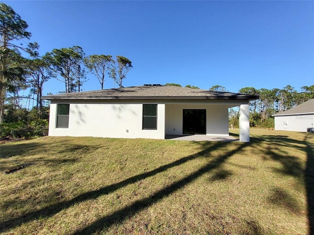 back of property featuring a yard and a patio