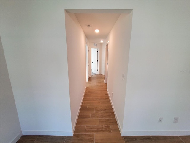 corridor with dark wood-type flooring