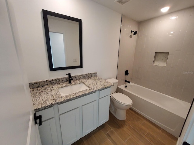 full bathroom with toilet, shower / washtub combination, wood finished floors, and vanity