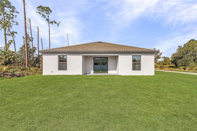 3560 Bellefonte Ave, North Port, FL 34286 - rear view of house featuring a lawn, stucco siding, and roof with shingles