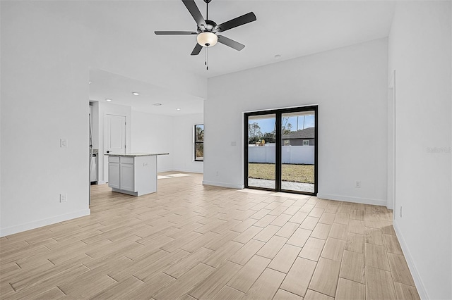 3560 Bellefonte Ave, North Port, FL 34286 - unfurnished living room featuring baseboards, ceiling fan, and wood tiled floor