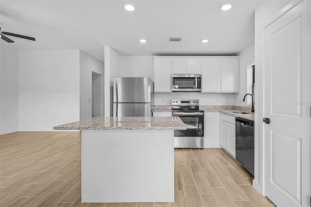 3560 Bellefonte Ave, North Port, FL 34286 - kitchen featuring wood finish floors, a center island, a sink, visible vents, and appliances with stainless steel finishes
