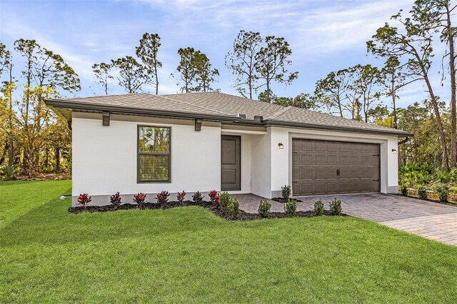 5237 Aberback St, North Port, FL 34291 - single story home with decorative driveway, an attached garage, a front lawn, stucco siding, and a shingled roof