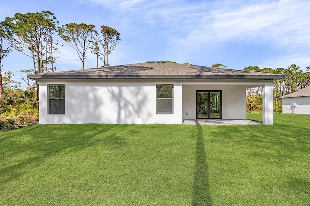 5237 Aberback St, North Port, FL 34291 - back of property with stucco siding, a patio area, and a lawn