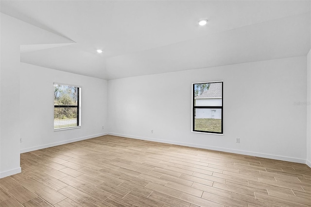 5237 Aberback St, North Port, FL 34291 - spare room with recessed lighting, baseboards, vaulted ceiling, and light wood-type flooring